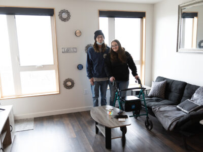 Man and woman stand in apartment