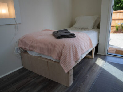Twin bed inside of a sleeping pod.