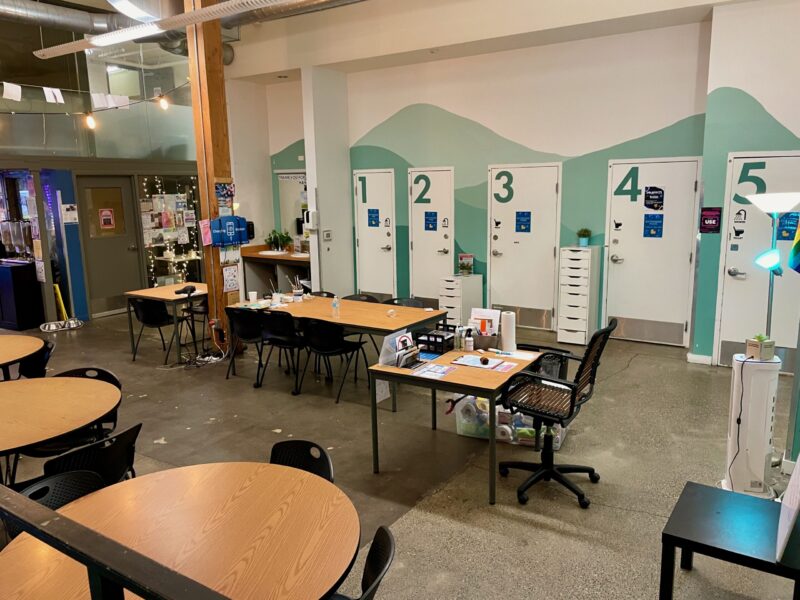 Large room with multiple tables and chairs