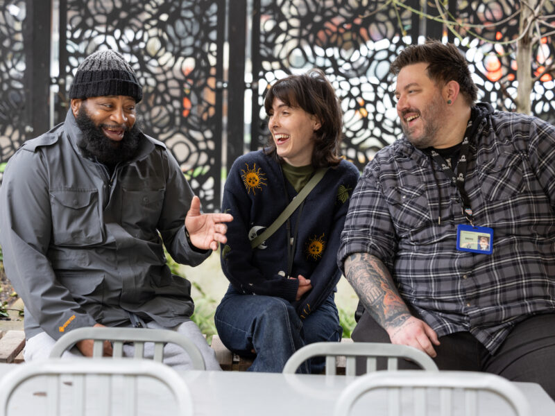 John meets recently with Mia Edera middle and Dane Achalas right of Do Good Multnomah in the courtyard at Behavioral Health Resource Center.